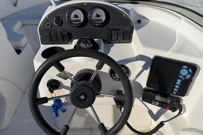 Slide: The Image of 2006 Boston Whaler 180 Ventura dashboard with steering wheel, gauges, and navigation equipment. - 10