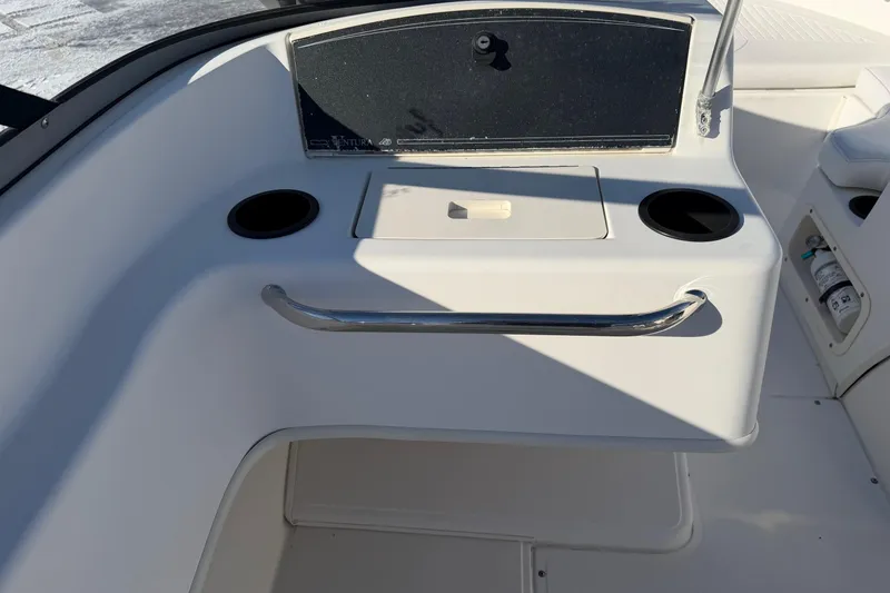Slide: The Image of 2006 Boston Whaler 180 Ventura boat interior with cup holders and storage compartment. - 11