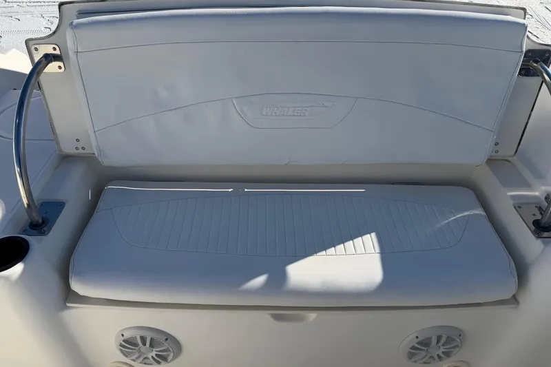 Slide: The Image of 2006 Boston Whaler 180 Ventura boat seat with white upholstery and integrated speakers. - 12