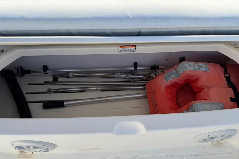 Slide: The Image of Storage compartment of 2006 Boston Whaler 180 Ventura with life jacket and equipment. - 13