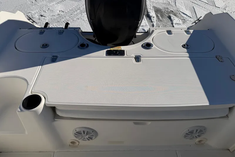 Slide: The Image of 2006 Boston Whaler 180 Ventura boat deck with storage compartments and cup holder. - 14