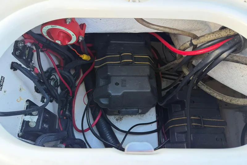 Slide: The Image of Electrical compartment of a 2006 Boston Whaler 180 Ventura boat, showing battery and wiring. - 15