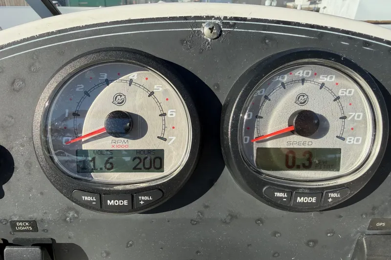 Slide: The Image of Dashboard of a 2006 Boston Whaler 180 Ventura boat showing RPM and speed gauges. - 17