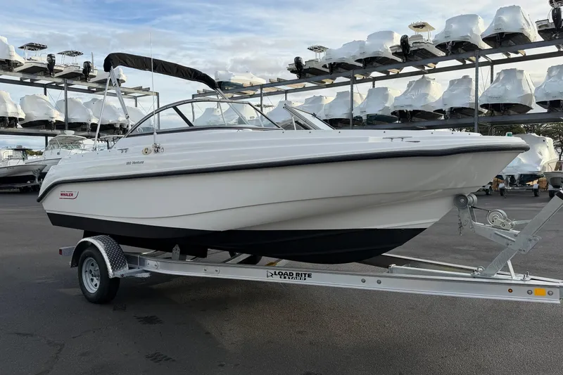 Slide: The Image of 2006 Boston Whaler 180 Ventura boat on trailer, parked in marina storage area. - 2