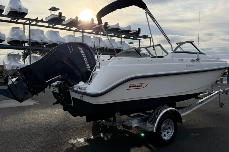 Slide: The Image of 2006 Boston Whaler 180 Ventura boat on trailer, with Mercury outboard motor, at marina. - 3