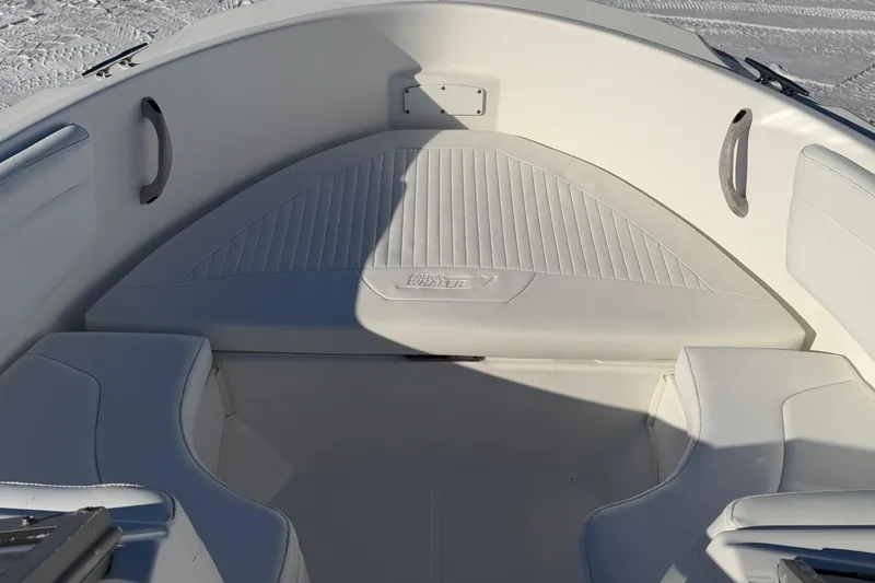 Slide: The Image of 2006 Boston Whaler 180 Ventura boat interior with white seating and handles. - 4