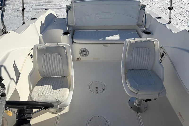 Slide: The Image of 2006 Boston Whaler 180 Ventura boat interior with white seating and steering wheel. - 8