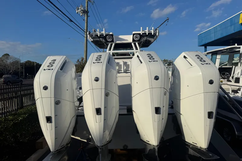 Slide: The Image of 2026 Blackfin 400 CC boat on stands, sleek black hull, outdoor display. - 2