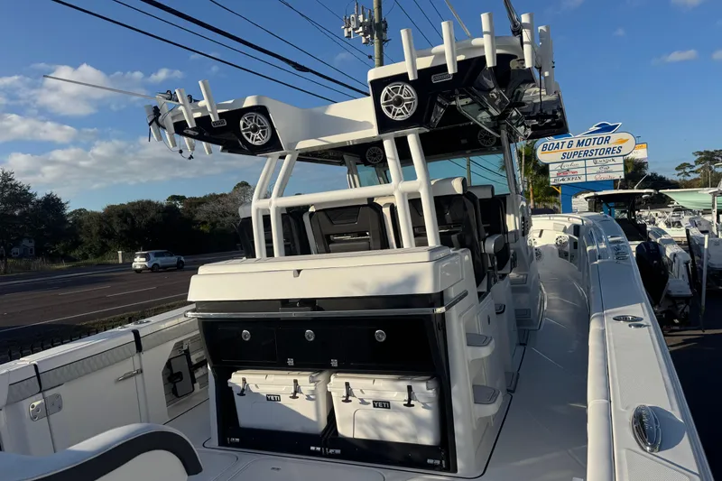 Slide: The Image of 2026 Blackfin 400 CC boat with four powerful V10 engines, docked under a clear sky. - 3