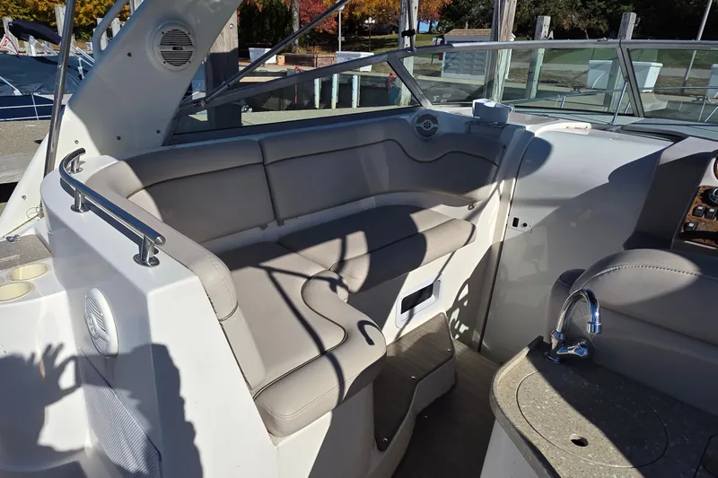 Slide: The Image of 2005 Rinker 300 Express Cruiser interior with seating and sink. - 10