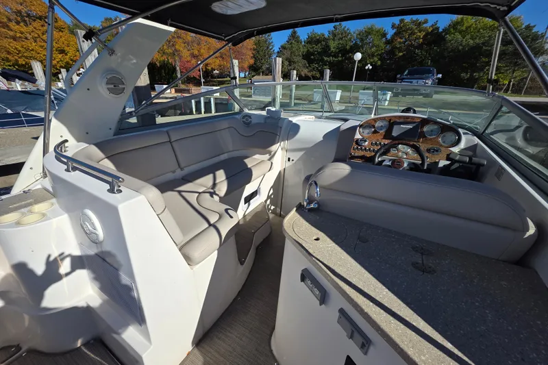Slide: The Image of 2005 Rinker 300 Express Cruiser interior with helm and seating area. - 11