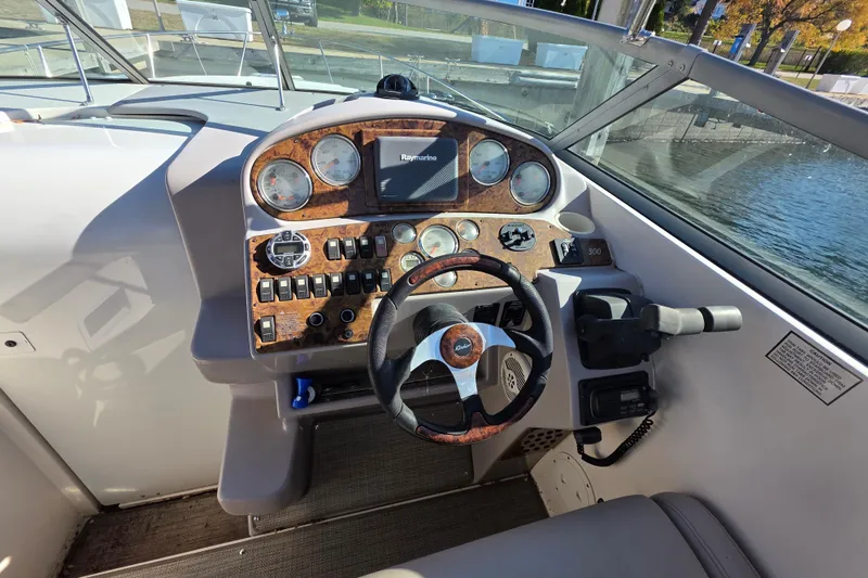 Slide: The Image of 2005 Rinker 300 Express Cruiser dashboard with steering wheel and control panel. - 15