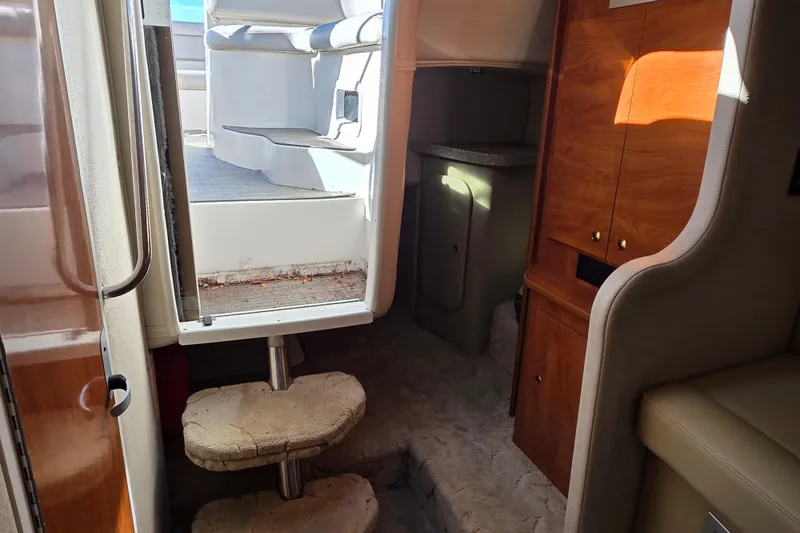 Slide: The Image of Interior view of 2005 Rinker 300 Express Cruiser with steps and wooden cabinetry. - 23