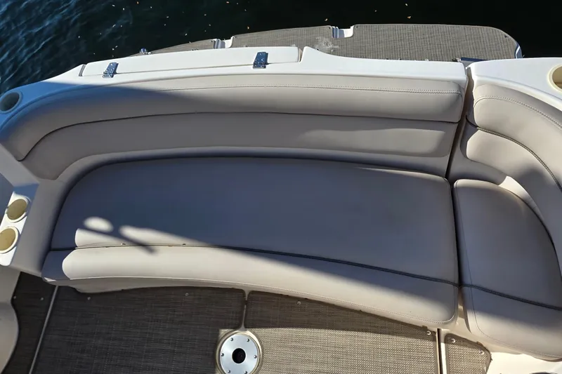 Slide: The Image of 2005 Rinker 300 Express Cruiser boat seating area with cup holders. - 7