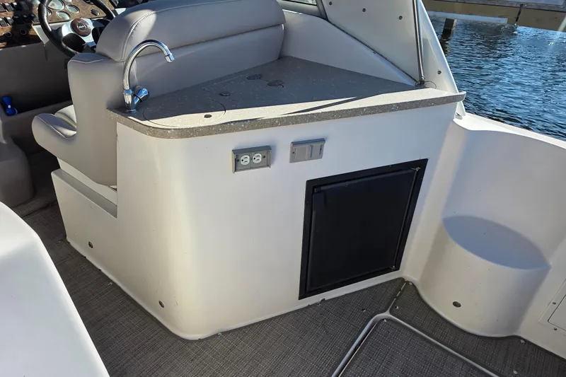 Slide: The Image of 2005 Rinker 300 Express Cruiser interior with sink, counter, and electrical outlet. - 8