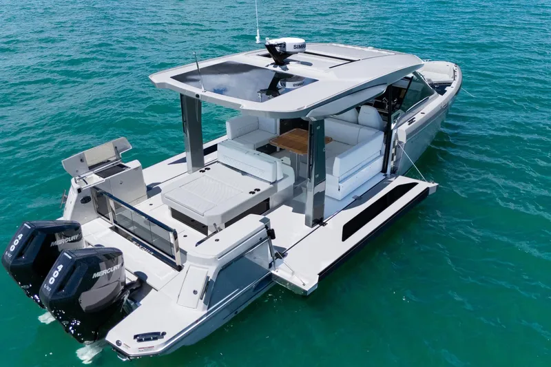 Slide: The Image of 2025 Saxdor 400 GTO luxury boat on clear blue water, featuring twin Mercury engines. - 1