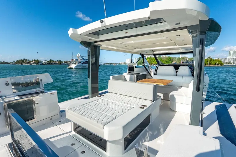 Slide: The Image of 2025 Saxdor 400 GTO luxury yacht interior with seating and table on open water. - 10