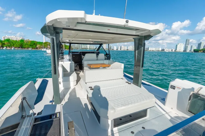 Slide: The Image of 2025 Saxdor 400 GTO luxury yacht on water with city skyline backdrop. - 11