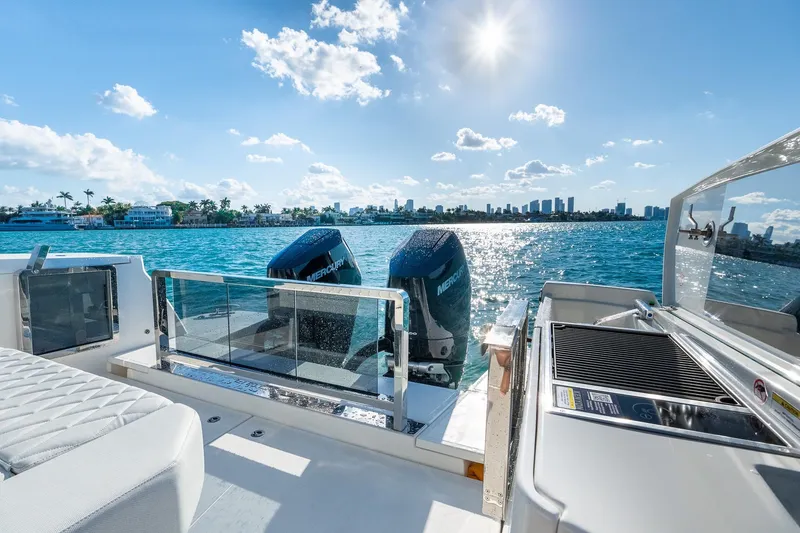 Slide: The Image of 2025 Saxdor 400 GTO boat with twin Mercury engines on a sunny day. - 12