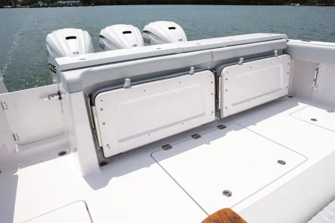 Slide: The Image of Manufacturer Provided Image: Aft view of Southport 38 FE boat, 2026 model, featuring three outboard engines. - 6