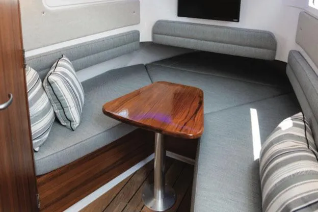 Slide: The Image of Manufacturer Provided Image: Interior of 2026 Southport 38 FE with gray upholstery and wooden table. - 7