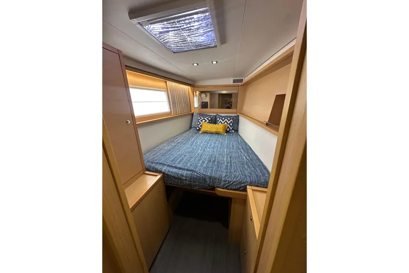 Slide: The Image of Cozy cabin interior of 2014 Lagoon 450 F yacht with bed and window. - 12