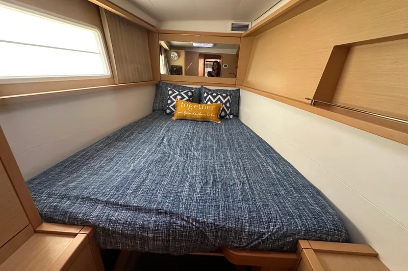 Slide: The Image of Cozy bedroom interior of 2014 Lagoon 450 F yacht with blue bedding and decorative pillows. - 20