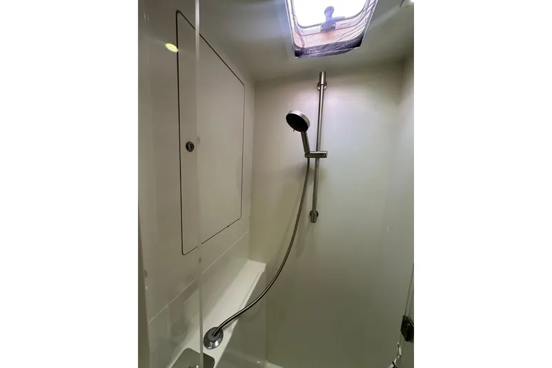 Slide: The Image of Shower area in 2014 Lagoon 450 F yacht with modern fixtures and overhead window. - 23