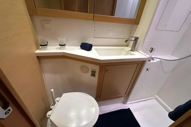 Slide: The Image of 2014 Lagoon 450 F yacht bathroom with modern fixtures and compact design. - 26