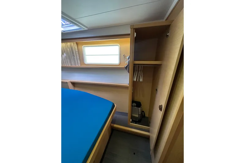 Slide: The Image of Interior cabin of 2014 Lagoon 450 F yacht with bed and open closet. - 28