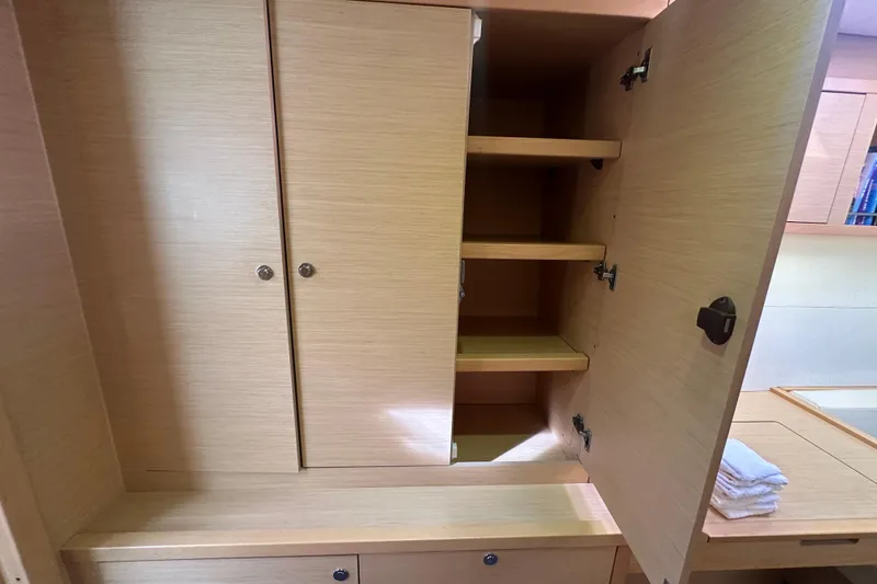 Slide: The Image of Open wooden cabinet with shelves inside a 2014 Lagoon 450 F yacht interior. - 32