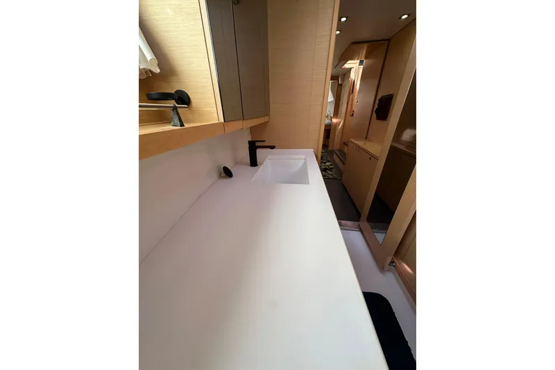 Slide: The Image of Bathroom interior of 2014 Lagoon 450 F yacht, featuring modern sink and cabinetry. - 37
