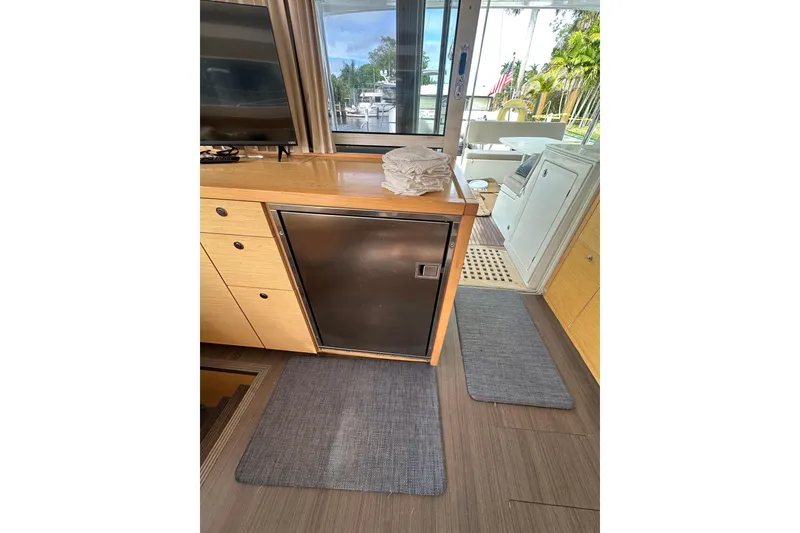 Slide: The Image of Interior of 2014 Lagoon 450 F yacht with modern kitchen and outdoor view. - 4