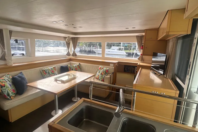 Slide: The Image of Interior of 2014 Lagoon 450 F catamaran with spacious seating and modern kitchen. - 49