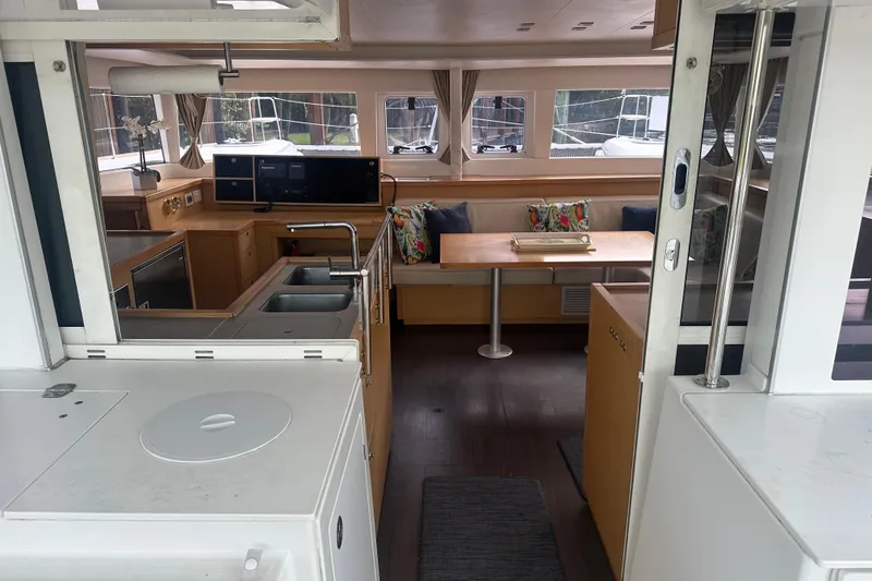 Slide: The Image of Interior of 2014 Lagoon 450 F catamaran, featuring modern kitchen and cozy dining area. - 51