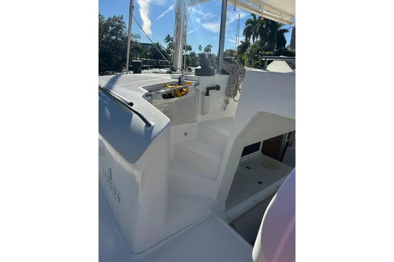 Slide: The Image of 2014 Lagoon 450 F yacht deck with stairs and railing under clear blue sky. - 54