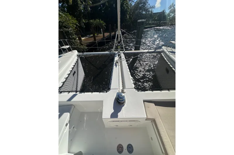 Slide: The Image of 2014 Lagoon 450 F catamaran deck with netting and water view. - 55