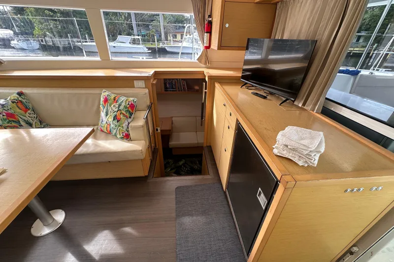 Slide: The Image of Interior of 2014 Lagoon 450 F yacht with seating, TV, and scenic window view. - 6