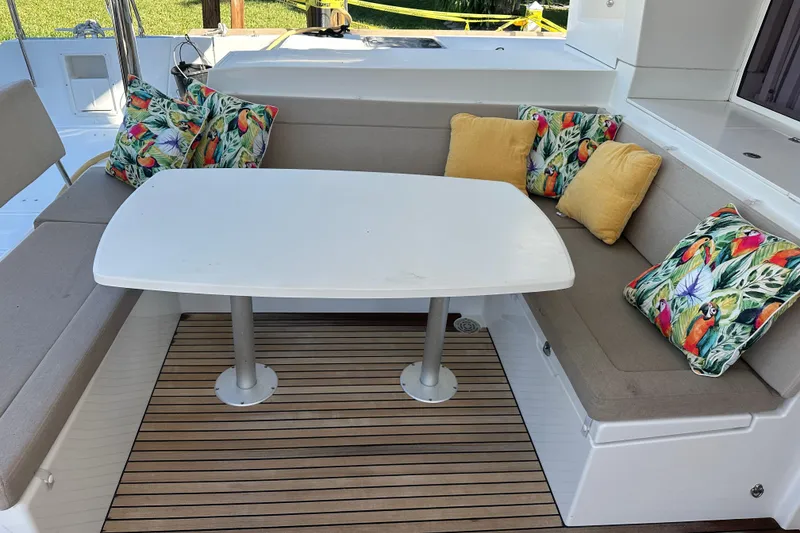 Slide: The Image of Outdoor seating area on 2014 Lagoon 450 F yacht with colorful cushions and table. - 60