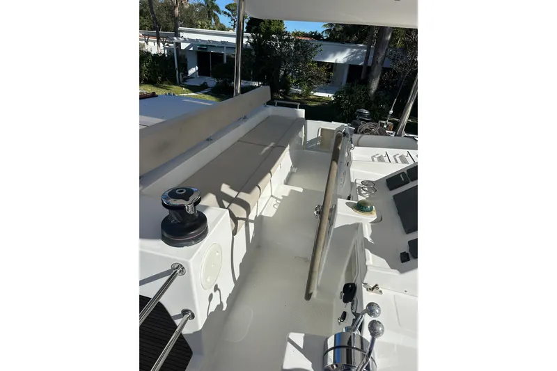 Slide: The Image of 2014 Lagoon 450 F yacht deck with steering wheel and seating area. - 62