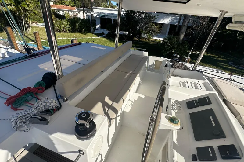 Slide: The Image of 2014 Lagoon 450 F yacht cockpit with seating, ropes, and navigation equipment. - 63