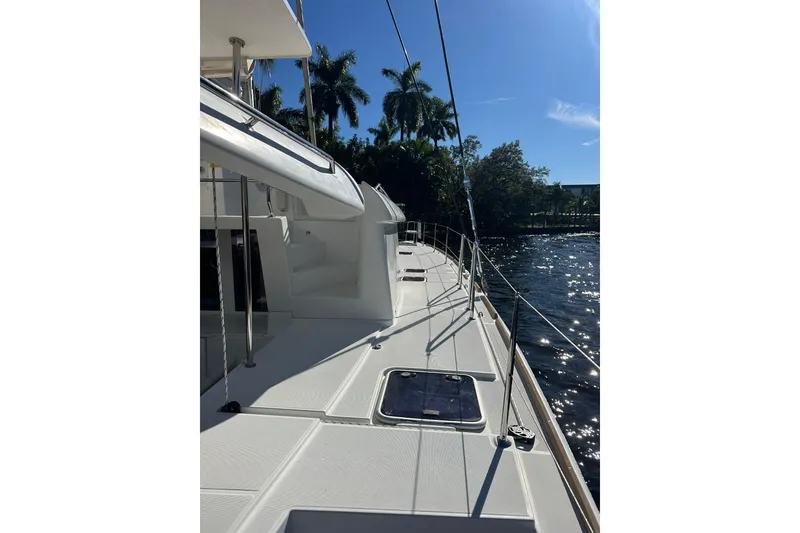 Slide: The Image of 2014 Lagoon 450 F catamaran deck with sunny waterfront view. - 69