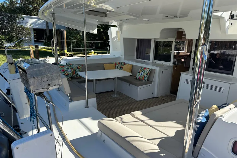 Slide: The Image of 2014 Lagoon 450 F catamaran deck with tropical backdrop and clear blue sky. - 73