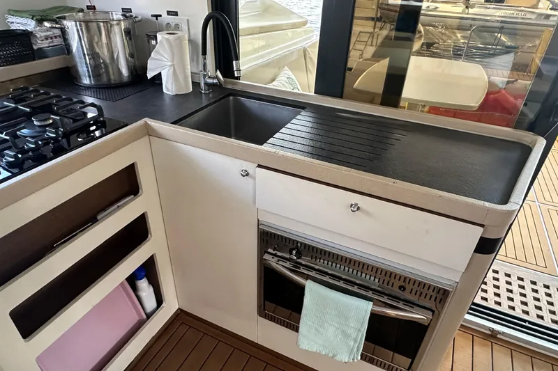 Slide: The Image of Modern kitchen in 2019 Lagoon 42 yacht with stove, sink, and oven. - 35