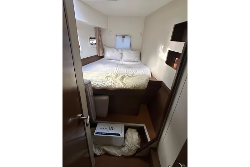 Slide: The Image of Cozy cabin interior of 2019 Lagoon 42 catamaran with bed and storage. - 42