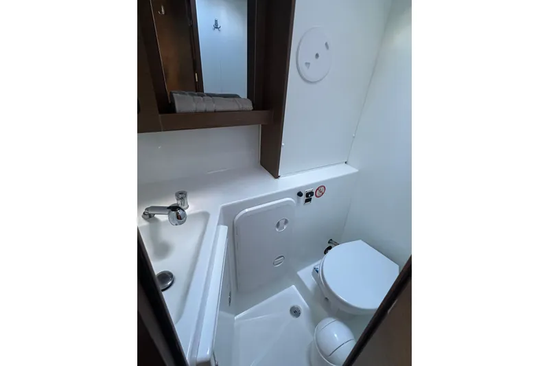 Slide: The Image of Compact bathroom in a 2019 Lagoon 42 yacht, featuring a toilet and sink. - 59