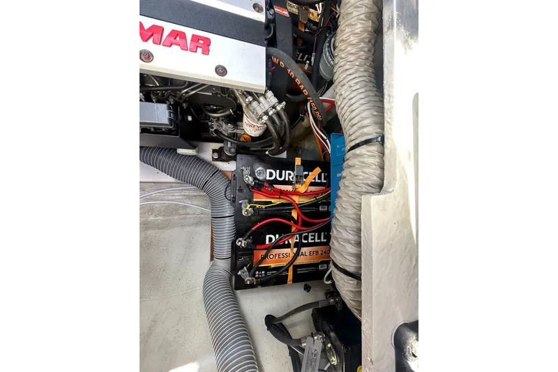 Slide: The Image of Engine compartment of a 2019 Lagoon 42 with Duracell batteries and wiring. - 64