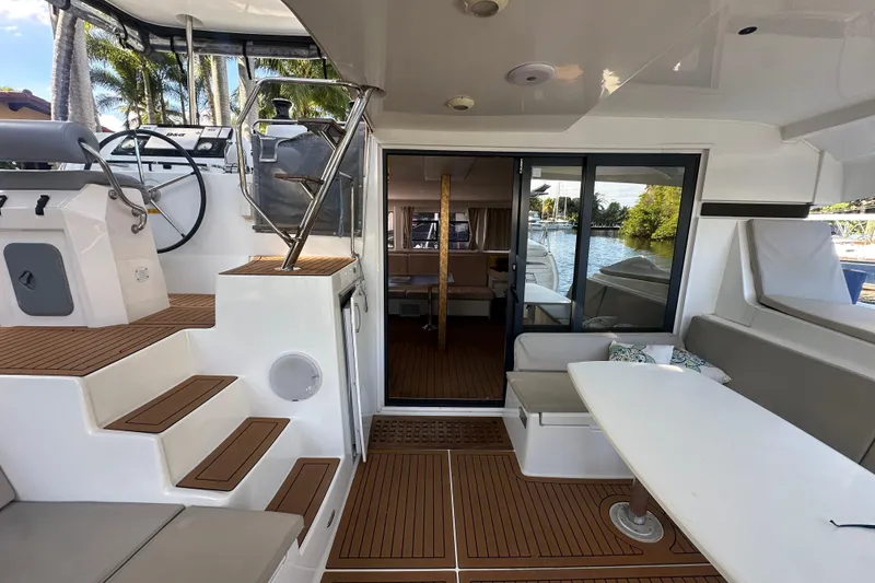 Slide: The Image of Luxurious 2019 Lagoon 42 catamaran interior with helm, seating, and scenic water view. - 7