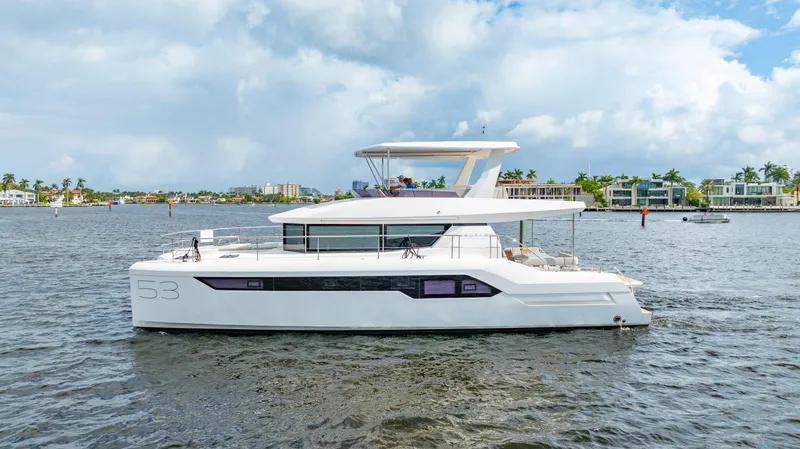 The Image of 2024 Leopard 53 Powercat yacht cruising on a scenic waterway. - 0