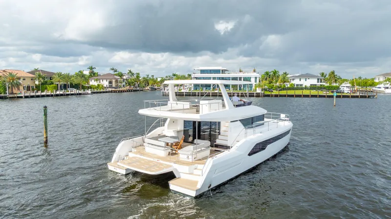 Slide: The Image of 2024 Leopard 53 Powercat yacht cruising on a scenic waterway. - 13